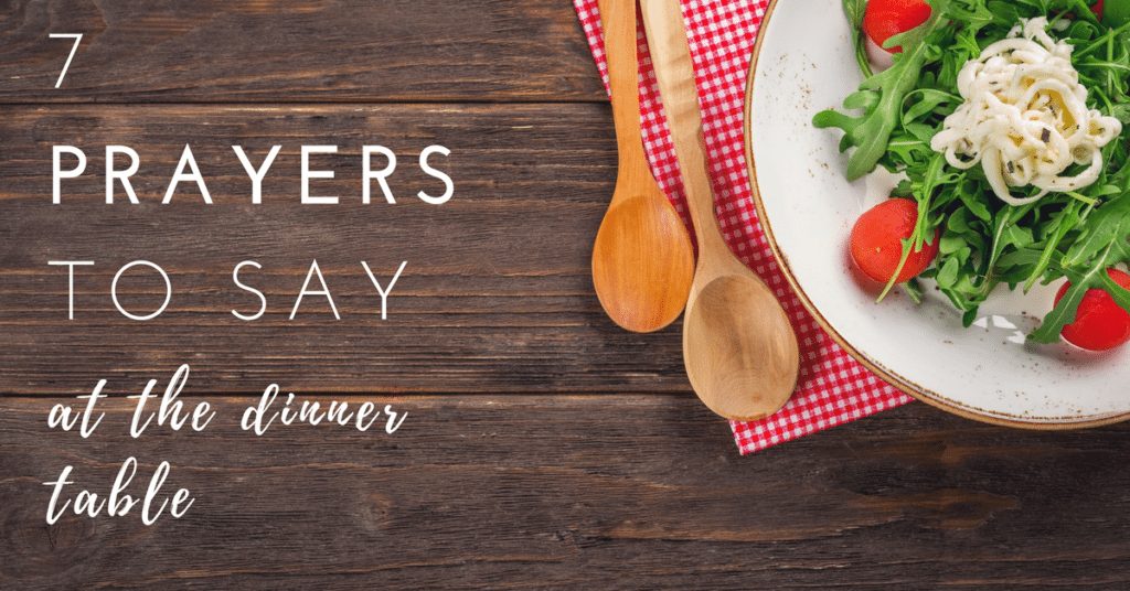 7 Prayers to Say at the Dinner Table|The Holy Mess, Common table prayer, plate of salad with a checkered red napkin and two wooden spoons. They sit on a wooden surface. 