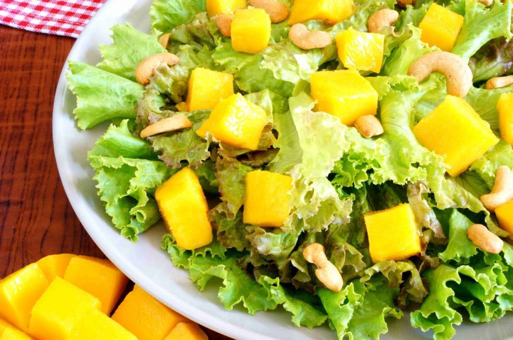 Mango Cashew Salad with chopped mango on table