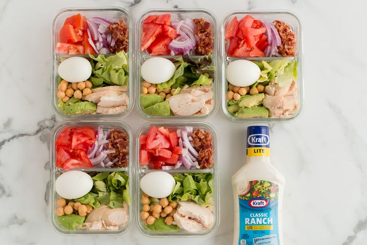 Five individual Weight Watchers Meal Prep Cobb Salads in glass meal prep containers with Kraft Light Ranch salad dressing along side them