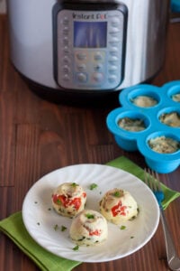 Instant Pot Starbucks Egg Bites for WW on a plate with pressure cooker