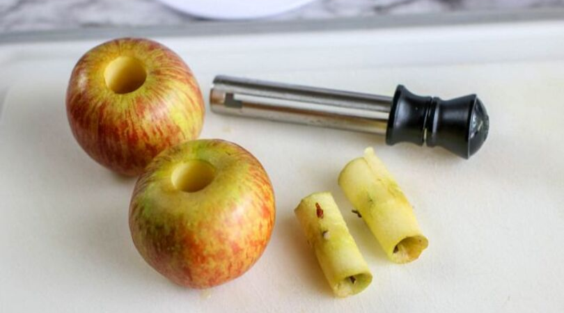 Air fryer apple chips, two cored apples sitting on cutting board