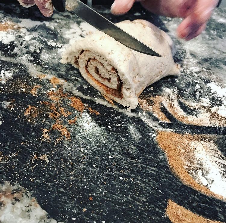 Slicing cinnamon rolls