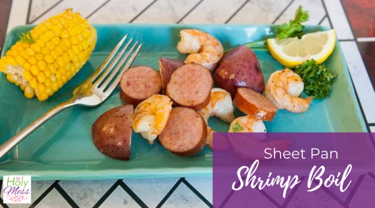 sheet pan shrimp boil on a blue plate with fork
