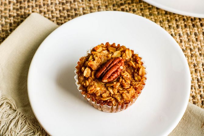 baked oatmeal recipe in a muffin cup on a white plate