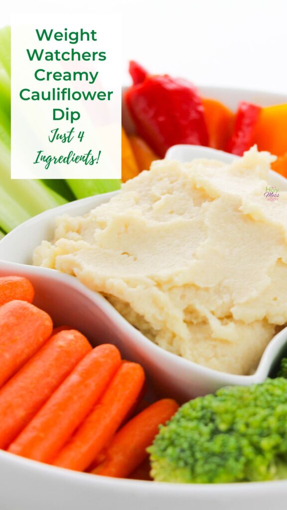 Creamy Cauliflower Dip in a small white bowl with fresh cut vegetables surrounding it