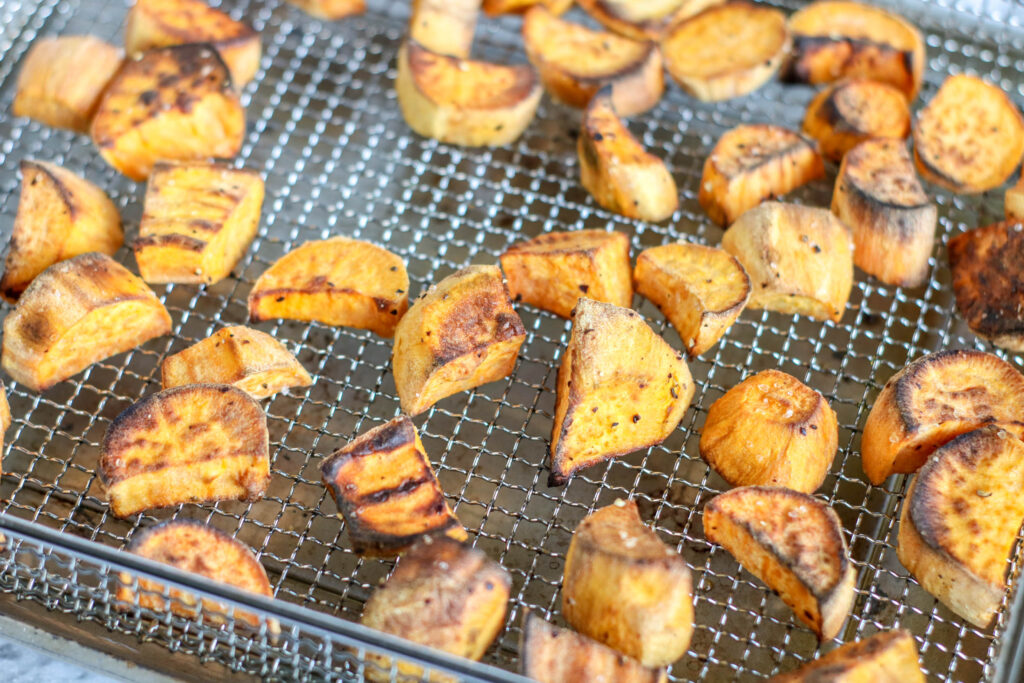 Roasted sweet potatoes in a metal air fryer basket