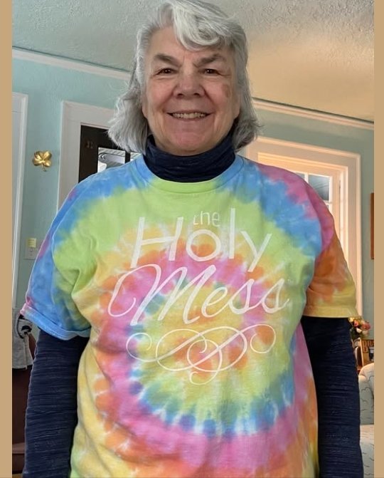 Holy Mess member in a soft tie dye The Holy Mess t-shirt