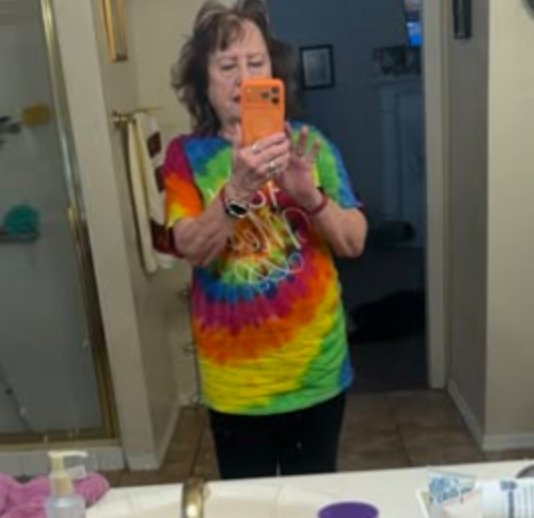 Holy Mess member in a bright tie dye The Holy Mess t-shirt