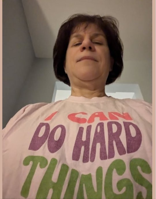Holy Mess member in a pink I Can Do Hard Things t-shirt