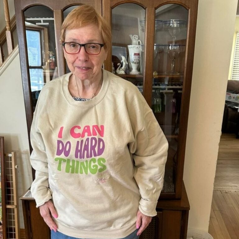 Holy Mess member in an I Can Do Hard Things sweatshirt